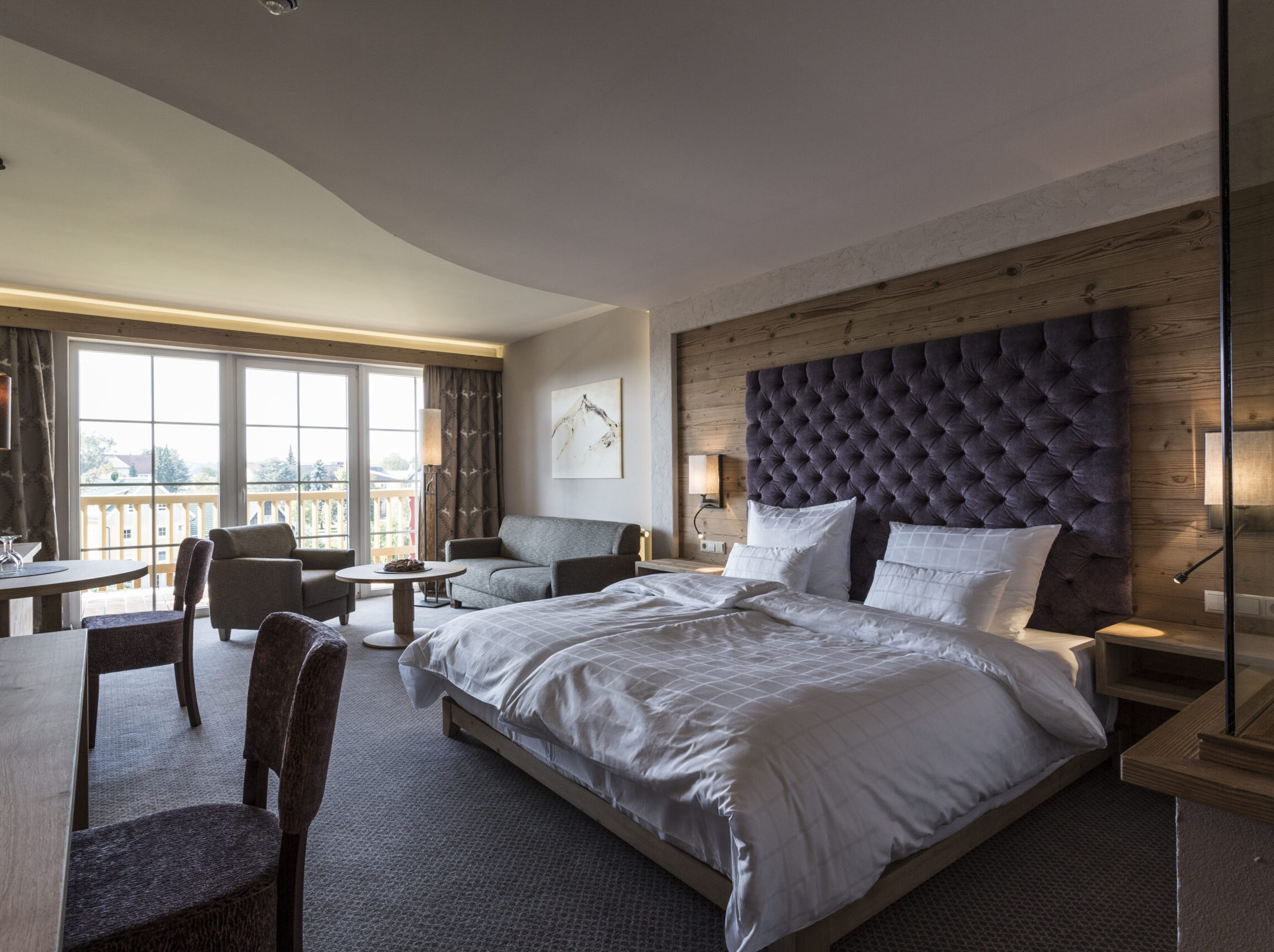 Junior Suite Superior mit Balkon für bis zu 5 Personen mit Doppelbett, Sitzecke und Balkonblick Richtung Süden
